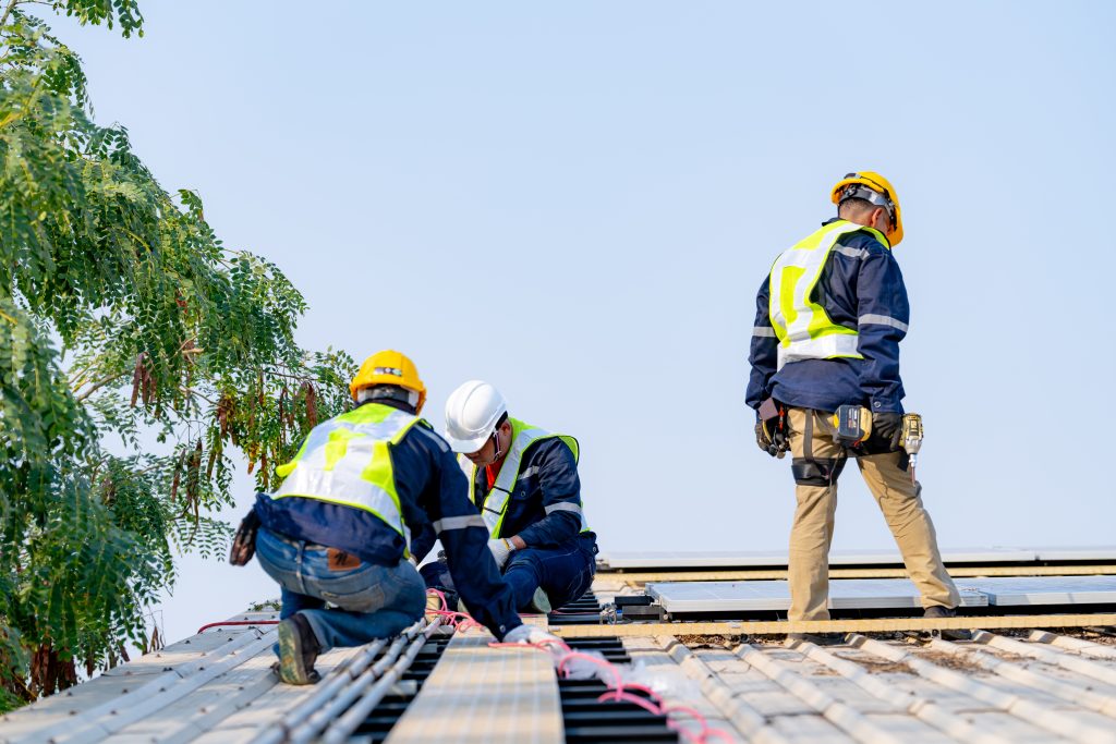 Construction workers installing solar panels